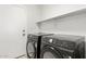 This laundry room includes a washer, dryer, and shelving at 28617 N 50Th Pl, Cave Creek, AZ 85331