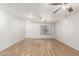 Inviting living room with wood floors, ceiling fan, and track lighting at 28617 N 50Th Pl, Cave Creek, AZ 85331