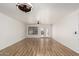 Bright living room with hardwood floors, fan, and french doors leading to the backyard at 28617 N 50Th Pl, Cave Creek, AZ 85331