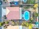 Aerial view of backyard featuring sparkling pool, built-in seating and lush landscaping at 31446 N Candlewood Dr, San Tan Valley, AZ 85143