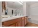 Bathroom featuring a long double sink vanity with tan tile flooring at 31446 N Candlewood Dr, San Tan Valley, AZ 85143