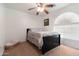 Comfortable bedroom featuring a ceiling fan, window, and neutral carpet and decor at 31446 N Candlewood Dr, San Tan Valley, AZ 85143