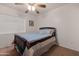 Bedroom with a ceiling fan, wood bed frame, and neutral carpeting at 31446 N Candlewood Dr, San Tan Valley, AZ 85143