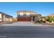 Charming two-story home featuring a red tile roof and spacious three-car garage at 31446 N Candlewood Dr, San Tan Valley, AZ 85143