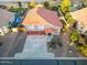 Aerial view of gray home featuring a red tile roof, three-car garage, and landscaped yard at 31446 N Candlewood Dr, San Tan Valley, AZ 85143