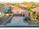 Aerial view of a beautiful gray two-story home with a red tile roof and three-car garage at 31446 N Candlewood Dr, San Tan Valley, AZ 85143