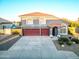 Exterior view of a gray home showcasing a red tile roof, three-car garage, and a well-maintained yard at 31446 N Candlewood Dr, San Tan Valley, AZ 85143