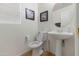 Neat powder room with pedestal sink, mirror, and neutral walls; great for guests at 31446 N Candlewood Dr, San Tan Valley, AZ 85143