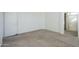 Spacious bedroom featuring neutral carpet and white walls, adjacent to a bathroom with a shower at 3313 E Waltann Ln, Phoenix, AZ 85032