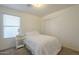 Bedroom featuring neutral paint, plush bedding, a window with blinds, and a closet at 3313 E Waltann Ln, Phoenix, AZ 85032