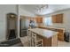 Well-lit kitchen with stainless steel appliances and a breakfast bar, perfect for casual dining at 3313 E Waltann Ln, Phoenix, AZ 85032