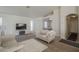 Cozy living room featuring an entertainment center, fireplace, and adjacent music room at 3313 E Waltann Ln, Phoenix, AZ 85032