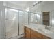 En suite bathroom featuring a glass-enclosed shower and vanity with a built-in sink at 3313 E Waltann Ln, Phoenix, AZ 85032