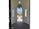 Inviting entryway featuring arched windows and a decorative light fixture, offering a glimpse of the landscaped front yard at 3675 E Strawberry Dr, Gilbert, AZ 85298