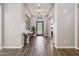 Elegant entryway with wood floors, complemented by neutral walls, stylish lighting, and a decorative table at 3675 E Strawberry Dr, Gilbert, AZ 85298