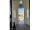 View through the arched doorway, showcases the brick pathway and manicured lawn at 3675 E Strawberry Dr, Gilbert, AZ 85298