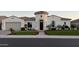 Charming home features a turret entryway, lush landscaping, and an attached two-car garage at 3675 E Strawberry Dr, Gilbert, AZ 85298
