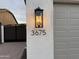 Close-up of the house number on the exterior wall next to a decorative outdoor lantern at 3675 E Strawberry Dr, Gilbert, AZ 85298