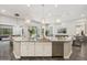 Gourmet kitchen featuring an island, granite countertops, stainless steel appliances, and modern pendant lighting at 3675 E Strawberry Dr, Gilbert, AZ 85298