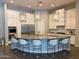 Well-equipped kitchen with a large island, stainless steel appliances, and stylish white seating at 3675 E Strawberry Dr, Gilbert, AZ 85298