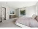 A serene main bedroom with natural light, soft carpet, and an outdoor view at 3675 E Strawberry Dr, Gilbert, AZ 85298