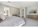 A spacious main bedroom featuring neutral tones, soft carpet and ensuite access at 3675 E Strawberry Dr, Gilbert, AZ 85298