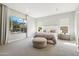 Serene main bedroom with natural light, neutral decor, and a view of the backyard pool at 3675 E Strawberry Dr, Gilbert, AZ 85298