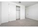 Bright bedroom with soft carpeting, closet with sliding doors, and a doorway leading to the rest of the home at 40218 N Alegre Dr, San Tan Valley, AZ 85140