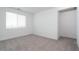 Bright bedroom with plush carpet and large window at 40218 N Alegre Dr, San Tan Valley, AZ 85140