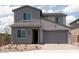 Charming two-story home showcasing a gray exterior, complemented by a well-maintained front yard at 40218 N Alegre Dr, San Tan Valley, AZ 85140