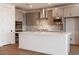 Modern kitchen featuring stainless steel appliances, a central island, and sleek gray cabinets at 40218 N Alegre Dr, San Tan Valley, AZ 85140