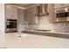 Close-up of kitchen with stainless steel appliances, white countertops, and stylish backsplash at 40218 N Alegre Dr, San Tan Valley, AZ 85140
