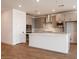 Modern kitchen with stainless steel appliances, a large island, and stylish gray cabinetry at 40218 N Alegre Dr, San Tan Valley, AZ 85140