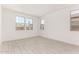 Bright bedroom with tile flooring and multiple windows allowing ample natural light at 40531 W Michaels Dr, Maricopa, AZ 85138