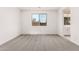 A carpeted bedroom with a window offers a bright and comfortable living space at 40531 W Michaels Dr, Maricopa, AZ 85138