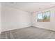 This bedroom features neutral carpet, a window and white walls offering a peaceful space at 40531 W Michaels Dr, Maricopa, AZ 85138