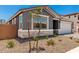 Charming single story home with a gray exterior, manicured gravel landscaping, and a two-car garage at 40531 W Michaels Dr, Maricopa, AZ 85138