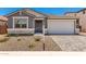 Charming home with gray stucco, stone accents, and a well-manicured front yard for curb appeal at 40531 W Michaels Dr, Maricopa, AZ 85138