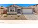Charming single-story home featuring a stone-accented facade and a well-maintained desert landscape in the front yard at 40531 W Michaels Dr, Maricopa, AZ 85138