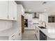 Modern kitchen with white cabinets, stainless steel appliances, and a center island with a sink at 40531 W Michaels Dr, Maricopa, AZ 85138