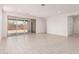 Spacious living room with a sliding glass door providing access to the backyard at 40531 W Michaels Dr, Maricopa, AZ 85138
