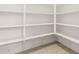 Walk-in pantry with multiple shelves and tile flooring at 40531 W Michaels Dr, Maricopa, AZ 85138
