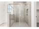 Walk-in shower with glass door, gray tile surround, and a window at 40531 W Michaels Dr, Maricopa, AZ 85138