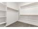 Carpeted walk-in closet with shelving and clothing racks at 40531 W Michaels Dr, Maricopa, AZ 85138