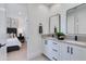 Modern bathroom featuring a double vanity, black fixtures, and an open view into the bedroom at 4302 E Marion Way, Phoenix, AZ 85018