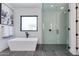 Elegant main bathroom featuring modern tub, glass shower, and designer fixtures at 4302 E Marion Way, Phoenix, AZ 85018