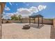 Backyard features brick pavers, pergola, pool, fire pit, and surrounding privacy walls at 44383 W Windrose Dr, Maricopa, AZ 85138