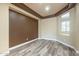 Comfortable bedroom with wood-look floors, a neutral color scheme, and natural light at 44383 W Windrose Dr, Maricopa, AZ 85138