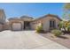 Spacious home with a three-car garage, desert landscaping and covered entry at 44383 W Windrose Dr, Maricopa, AZ 85138