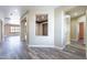 Open hallway with wood-look flooring and neutral paint, offering a seamless flow at 44383 W Windrose Dr, Maricopa, AZ 85138